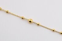 Zlatý náramok s guľôčkami,