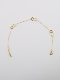 Zlatý náramok dekorovaný kruhmi