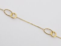 Zlatý náramok dekorovaný kruhmi