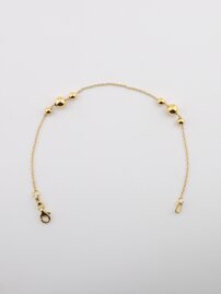 Zlatý náramok s guľôčkami,