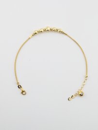 Zlatý náramok so žltými guľôčkami